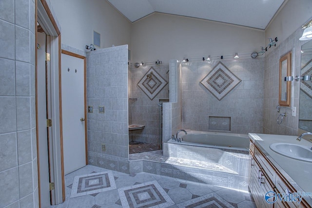 bathroom featuring lofted ceiling, vanity, shower with separate bathtub, and tile patterned floors