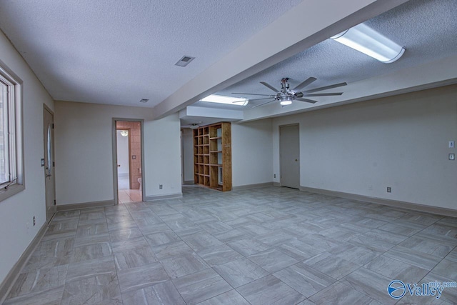 interior space featuring ceiling fan and a textured ceiling