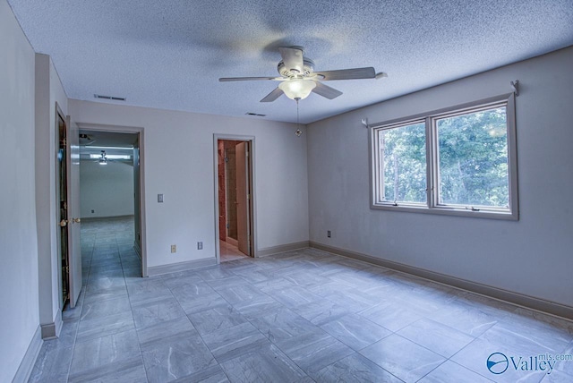 unfurnished bedroom featuring ceiling fan and a textured ceiling