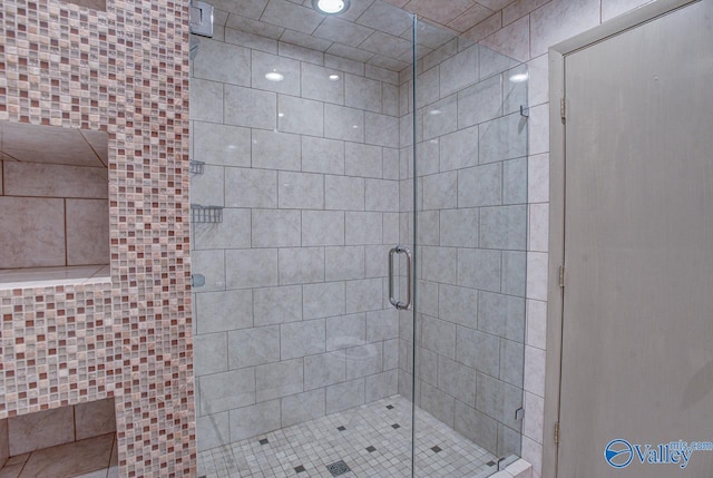 bathroom with a shower with shower door