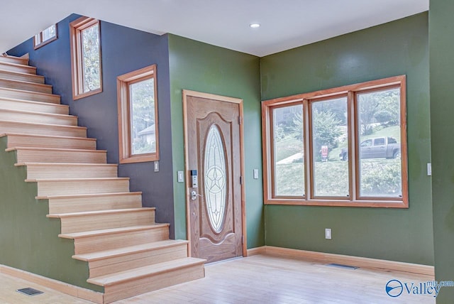 foyer with light hardwood / wood-style floors and a healthy amount of sunlight