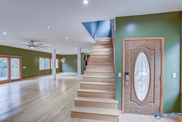 foyer with ceiling fan and light hardwood / wood-style flooring