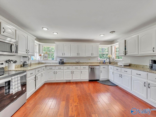 78 Bob Cir, Scottsboro, AL 35769 - kitchen with stainless steel appliances, healthy amount of natural light, white cabinetry, and recessed lighting