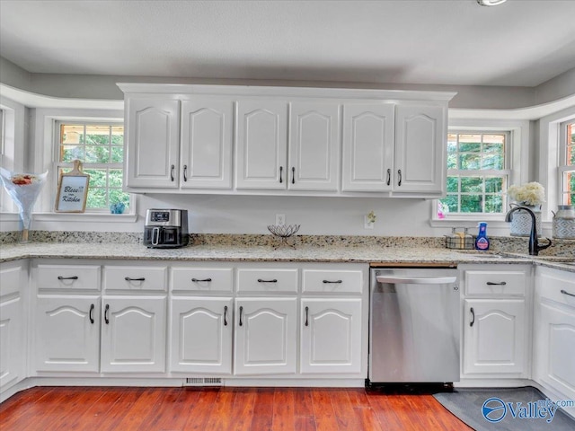 78 Bob Cir, Scottsboro, AL 35769 - kitchen with stainless steel dishwasher, a sink, healthy amount of natural light, and white cabinetry