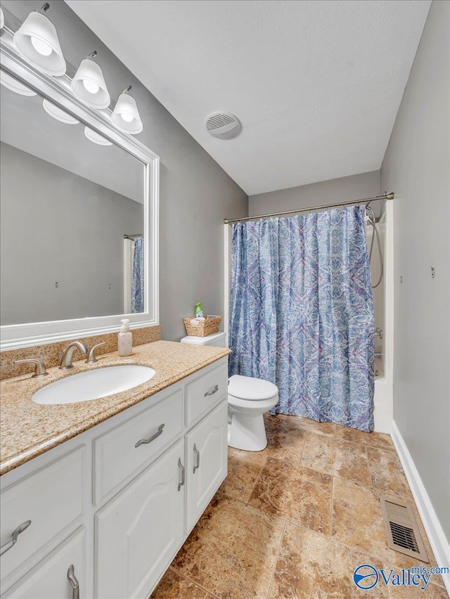 78 Bob Cir, Scottsboro, AL 35769 - full bath featuring vanity, stone finish flooring, toilet, and shower / tub combo with curtain