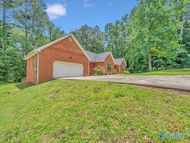 78 Bob Cir, Scottsboro, AL 35769 - view of front facade with brick siding, driveway, an attached garage, and a front yard
