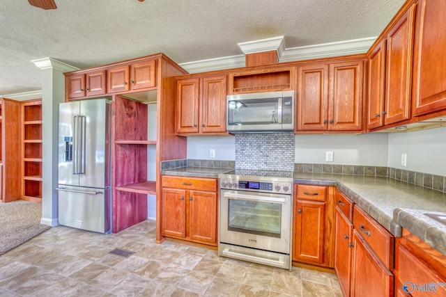 kitchen featuring appliances with stainless steel finishes, brown cabinets, and crown molding