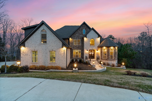 french country style house featuring a yard