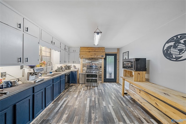 175 Short St, Geraldine, AL 35974 - kitchen with appliances with stainless steel finishes, a sink, wood finished floors, white cabinets, and blue cabinetry