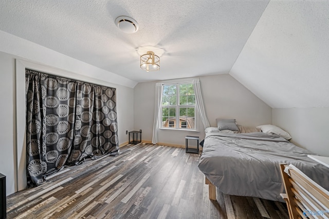 175 Short St, Geraldine, AL 35974 - bedroom featuring wood finished floors, a textured ceiling, and lofted ceiling