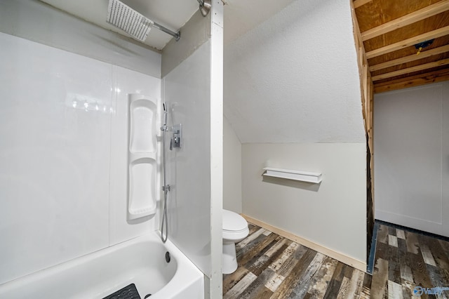 175 Short St, Geraldine, AL 35974 - bathroom featuring toilet, bathtub / shower combination, wood finished floors, vaulted ceiling, and baseboards