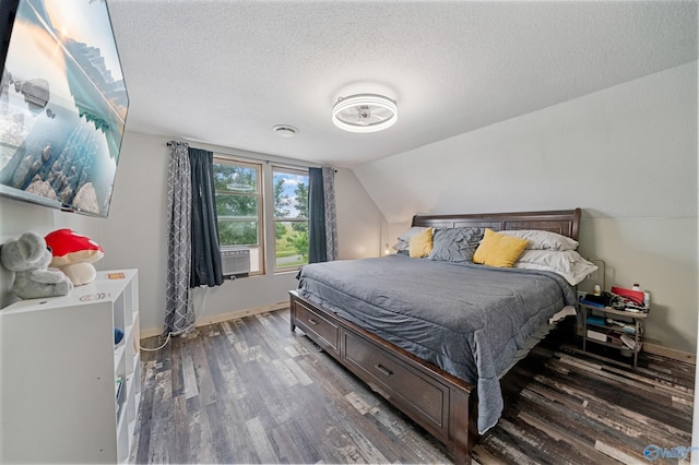 175 Short St, Geraldine, AL 35974 - bedroom featuring wood finished floors, vaulted ceiling, a textured ceiling, baseboards, and cooling unit