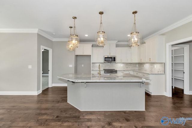 kitchen with white cabinetry, appliances with stainless steel finishes, dark hardwood / wood-style floors, and an island with sink