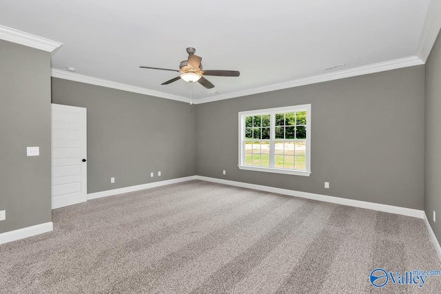 carpeted spare room with ceiling fan and crown molding