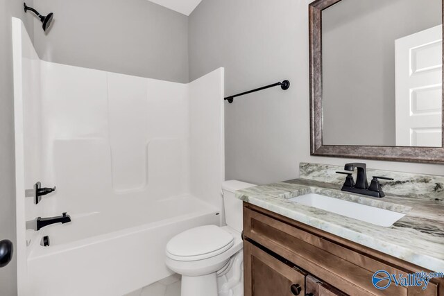 full bathroom featuring toilet, vanity, tile patterned flooring, and shower / washtub combination