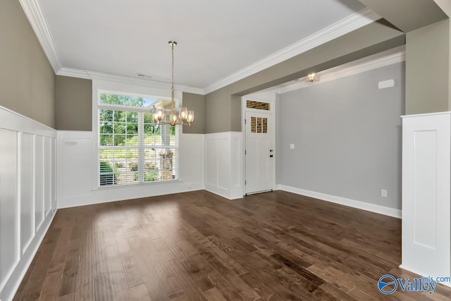 unfurnished dining area with dark wood-type flooring, an inviting chandelier, and ornamental molding