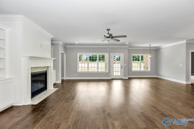 unfurnished living room with dark wood-type flooring, ceiling fan, and crown molding