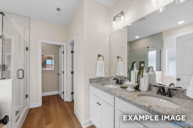 29555 Canoe Cir, Harvest, AL 35749 - bathroom with a shower stall, visible vents, wood finished floors, and a sink