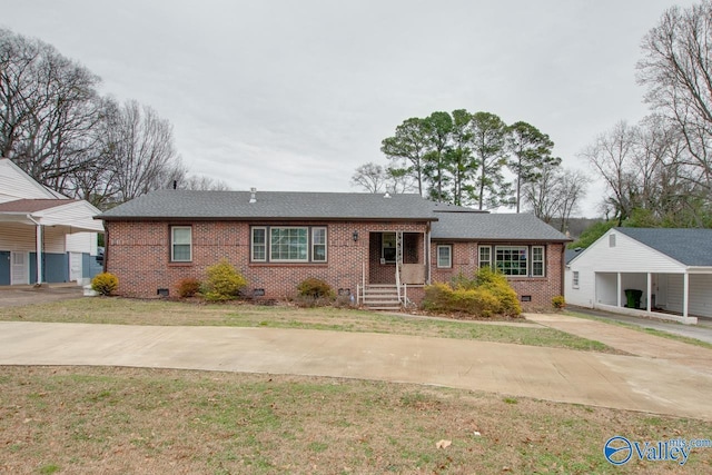 ranch-style house with a front lawn and a carport