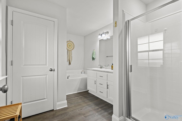 bathroom with vanity, a stall shower, wood finished floors, and a bath