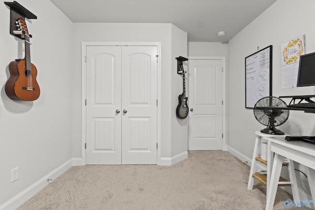 interior space featuring a closet, carpet flooring, and baseboards