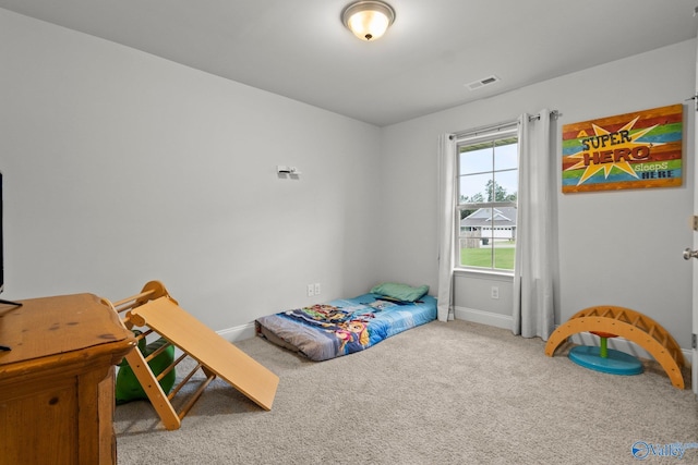 bedroom with baseboards, visible vents, and carpet flooring