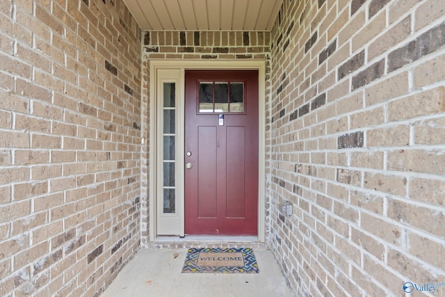 property entrance with brick siding