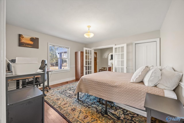 bedroom featuring french doors, a closet, and hardwood / wood-style flooring