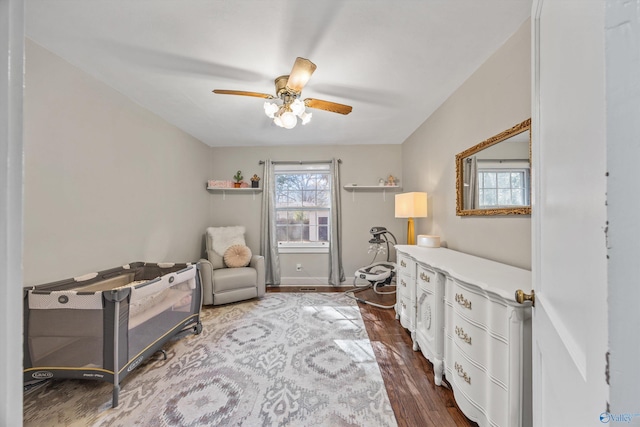 home office with ceiling fan and dark hardwood / wood-style flooring