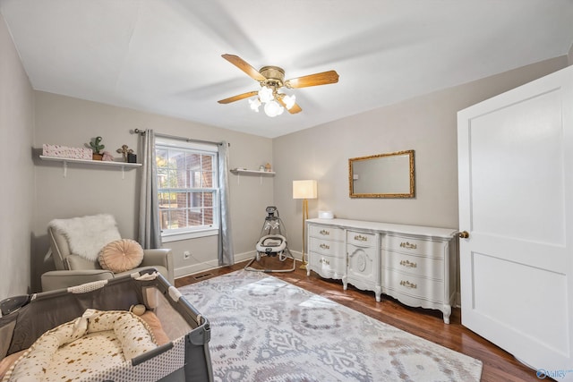 sitting room with ceiling fan and dark hardwood / wood-style flooring