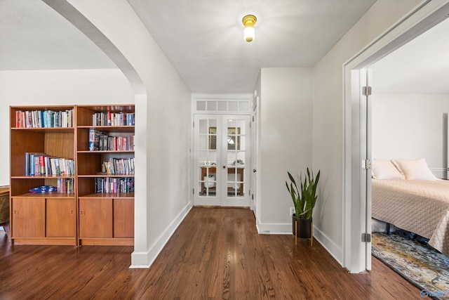 hallway featuring french doors and dark hardwood / wood-style floors