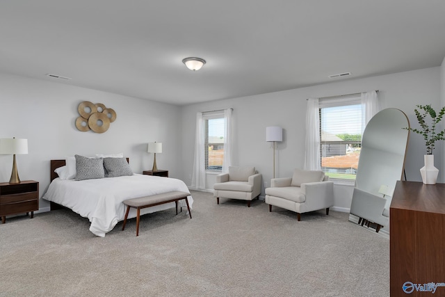 bedroom featuring visible vents, carpet flooring, baseboards, and multiple windows