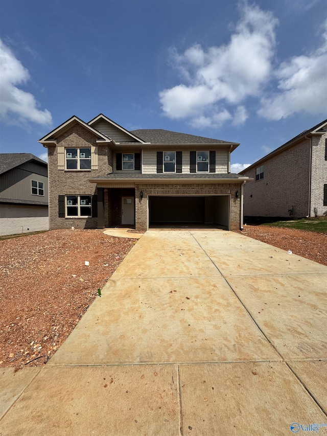 traditional-style home featuring brick siding, driveway, and a garage