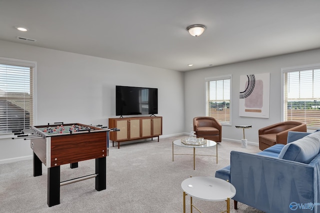 living room featuring recessed lighting, baseboards, light colored carpet, and visible vents
