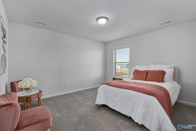 bedroom with baseboards, visible vents, and carpet