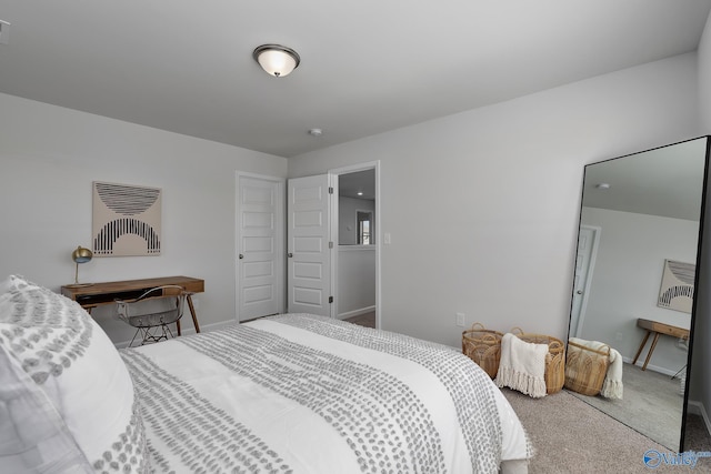 bedroom featuring baseboards and carpet