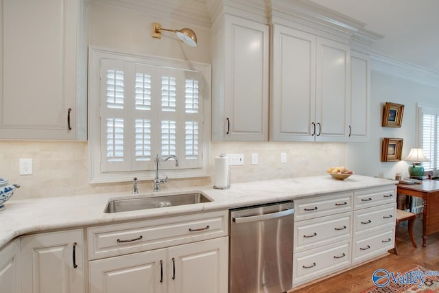 kitchen featuring stainless steel dishwasher, sink, white cabinetry, and light hardwood / wood-style flooring