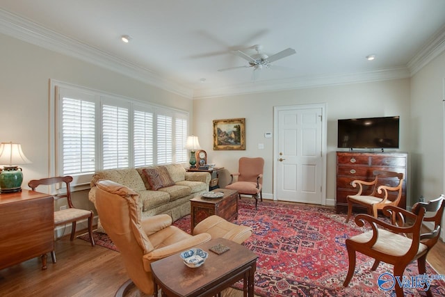 living room featuring ceiling fan, wood-type flooring, and ornamental molding