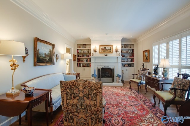 living room with hardwood / wood-style flooring, built in features, and ornamental molding