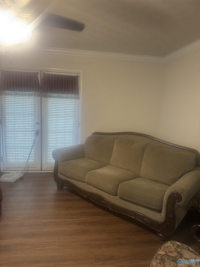 living area featuring wood finished floors and crown molding