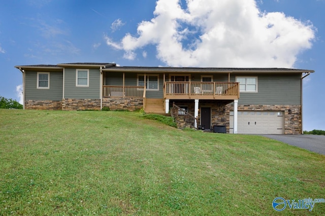 view of front facade featuring a front yard, driveway, stairway, and an attached garage