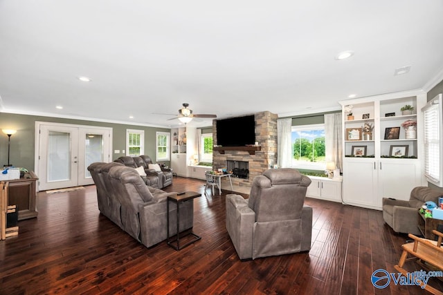 living room with a fireplace, french doors, a healthy amount of sunlight, and ornamental molding