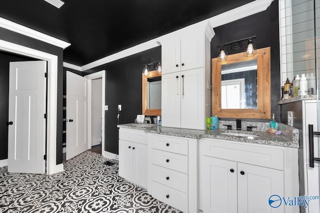 bathroom featuring double vanity, tile patterned floors, baseboards, and a sink