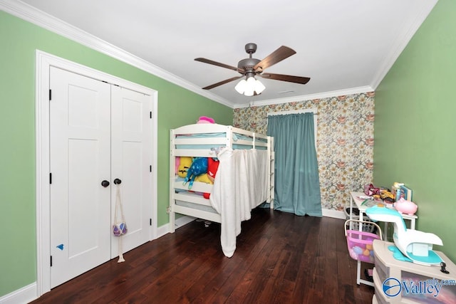bedroom featuring crown molding, wallpapered walls, hardwood / wood-style flooring, and baseboards