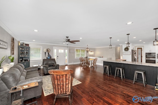 living room with crown molding, dark wood-style floors, a ceiling fan, and recessed lighting