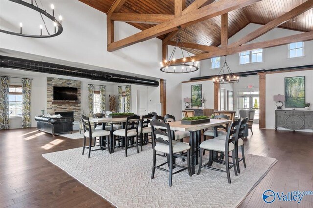 exercise room featuring wood ceiling, a high ceiling, and french doors