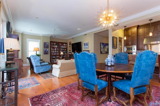 dining space featuring a notable chandelier, light wood-type flooring, and crown molding