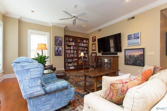 living room with ceiling fan, crown molding, and hardwood / wood-style floors