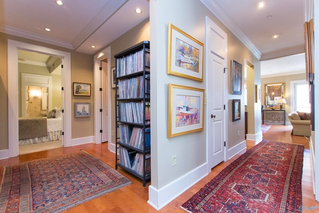 hallway featuring ornamental molding and wood-type flooring