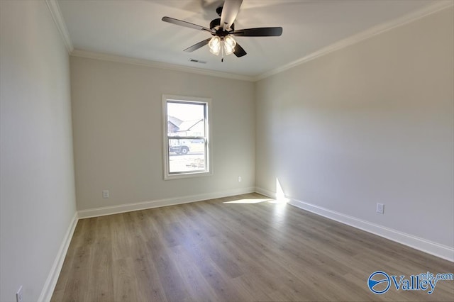 empty room with ornamental molding, ceiling fan, and light hardwood / wood-style floors